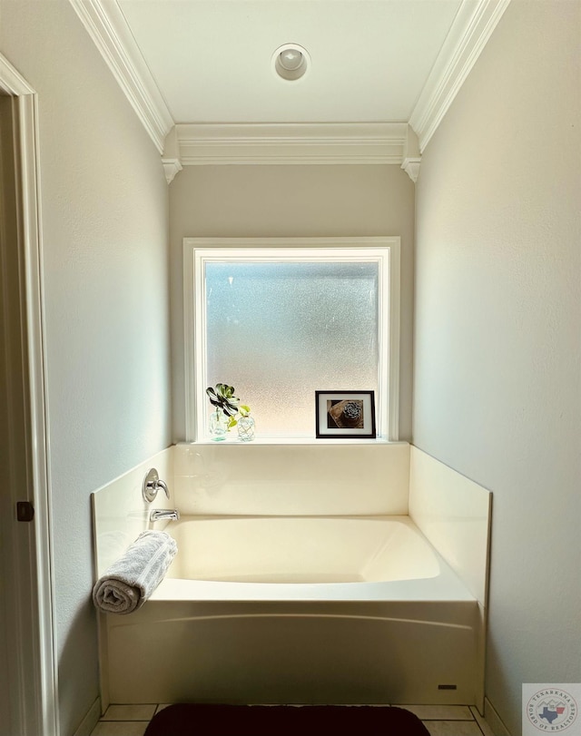 bathroom featuring ornamental molding, tile patterned flooring, and a bathing tub