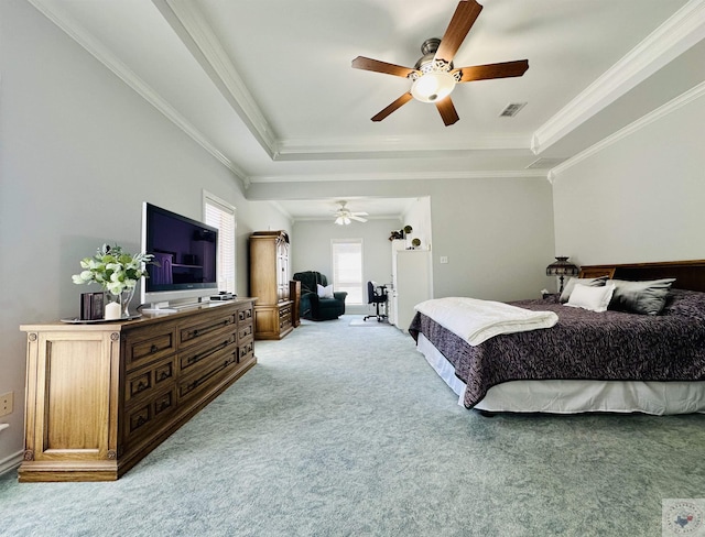 bedroom featuring ceiling fan, carpet, a tray ceiling, and ornamental molding