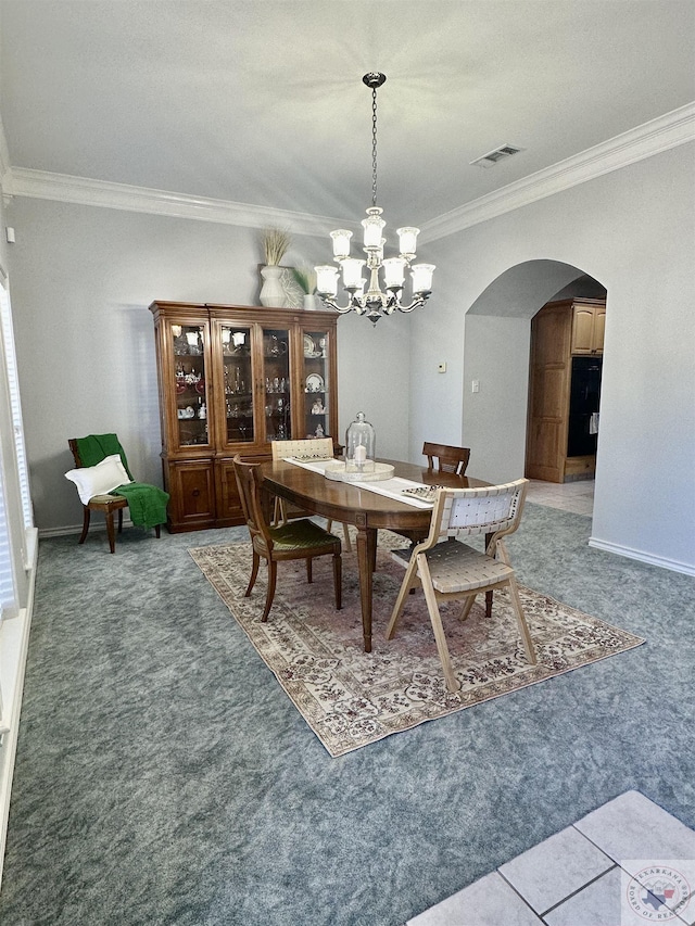 dining space with crown molding and a notable chandelier