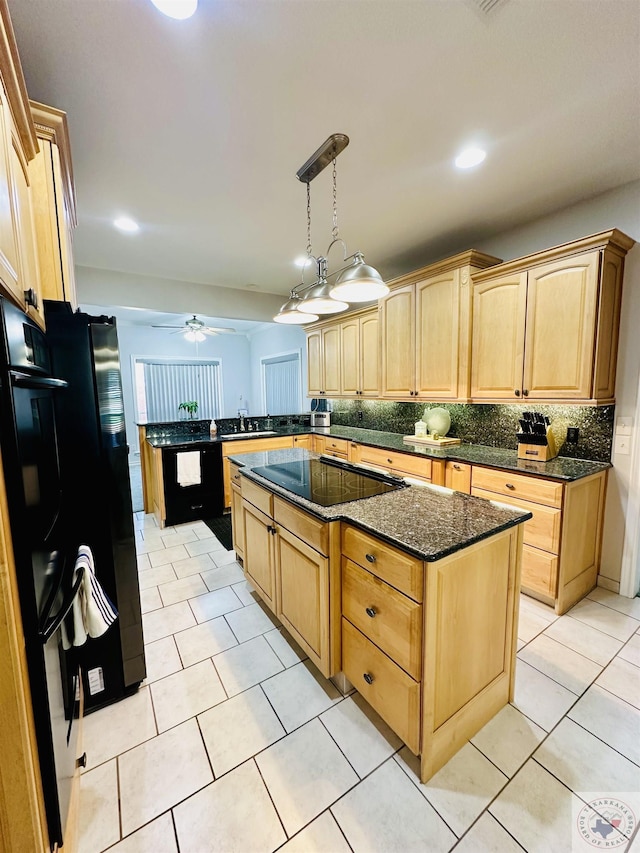 kitchen with kitchen peninsula, black appliances, pendant lighting, and light brown cabinetry