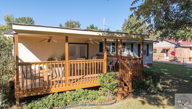 back of house featuring a yard, a wooden deck, and ceiling fan