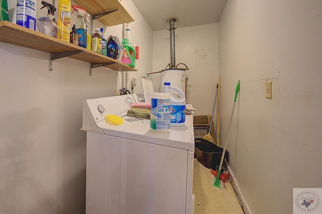 laundry room featuring water heater and washer / dryer