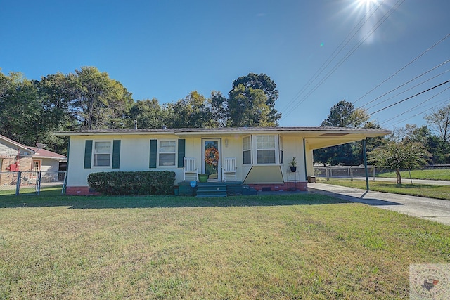 view of front of house with a front lawn and a carport