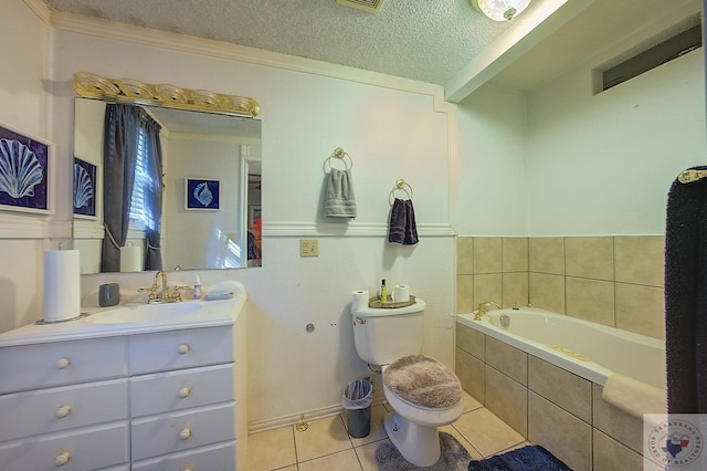 bathroom with tile patterned floors, tiled tub, toilet, a textured ceiling, and vanity