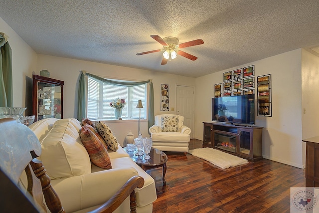 living room featuring a textured ceiling, dark hardwood / wood-style floors, and ceiling fan