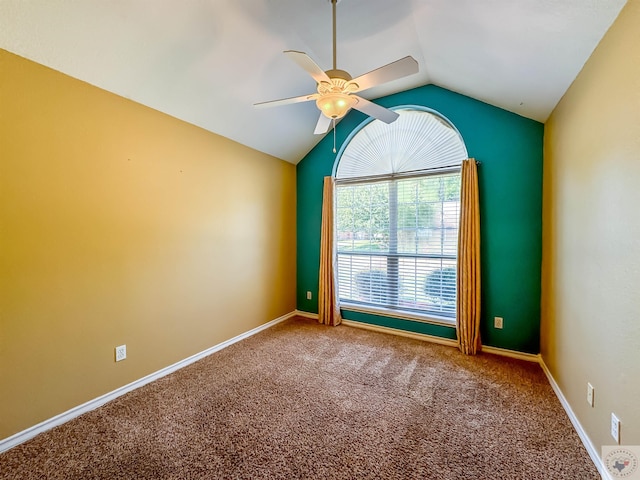 empty room with ceiling fan, carpet, and lofted ceiling