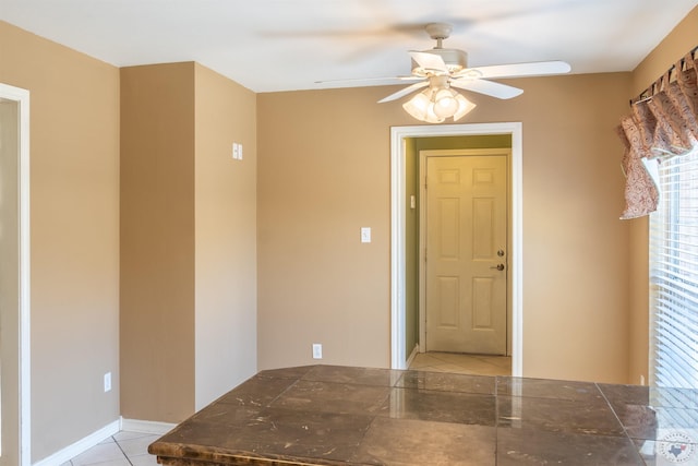 tiled foyer entrance with ceiling fan