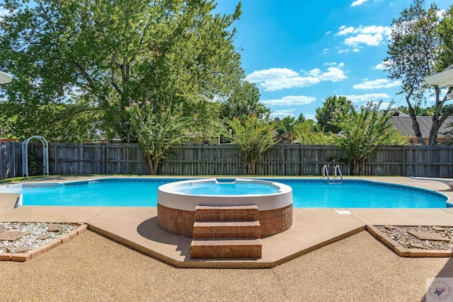 view of pool featuring a patio area and a hot tub