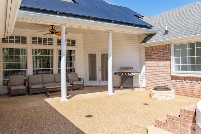 view of patio / terrace featuring french doors and an outdoor living space with a fire pit