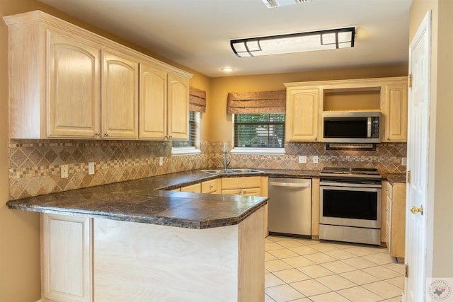 kitchen featuring appliances with stainless steel finishes, light brown cabinets, sink, kitchen peninsula, and light tile patterned floors