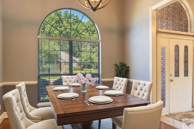 dining space with a chandelier and tile patterned flooring