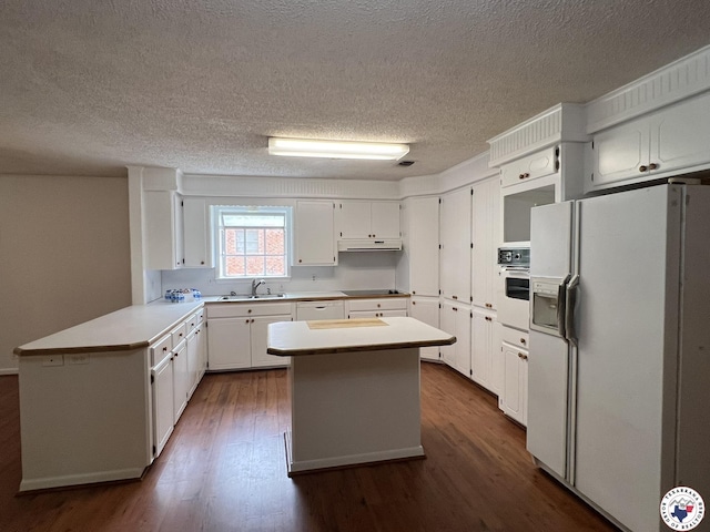 6 Arnold Dr, Texarkana, AR 71854 - kitchen with white appliances, a sink, under cabinet range hood, dark wood-style floors, and a kitchen island