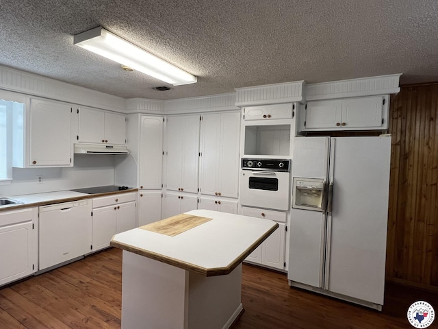 6 Arnold Dr, Texarkana, AR 71854 - kitchen featuring white appliances, dark wood finished floors, white cabinetry, under cabinet range hood, and a textured ceiling