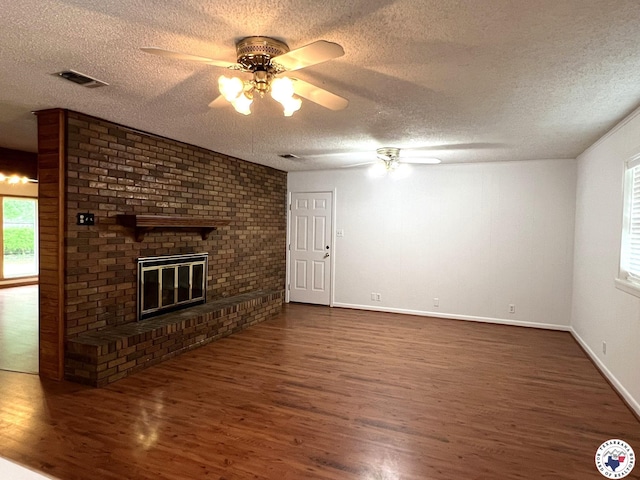 6 Arnold Dr, Texarkana, AR 71854 - unfurnished living room featuring a ceiling fan, dark wood-style floors, a textured ceiling, a fireplace, and baseboards