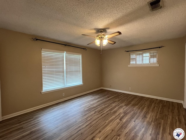 6 Arnold Dr, Texarkana, AR 71854 - spare room with ceiling fan, dark wood-style flooring, a textured ceiling, and baseboards