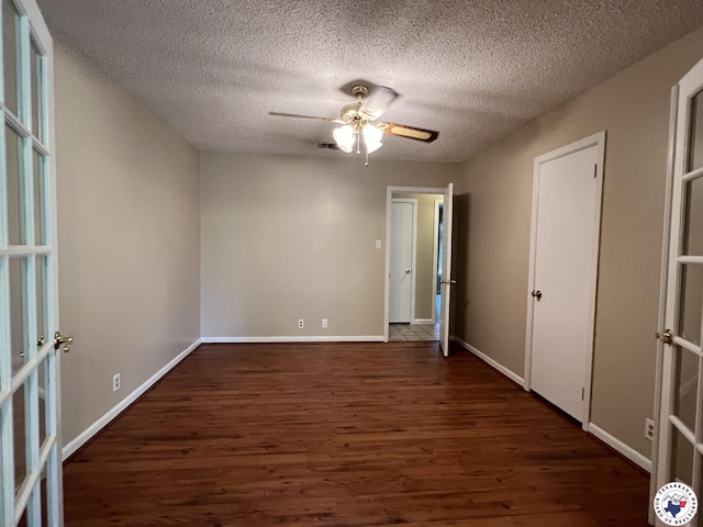 6 Arnold Dr, Texarkana, AR 71854 - empty room with wood finished floors, ceiling fan, a textured ceiling, baseboards, and french doors