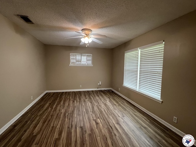 6 Arnold Dr, Texarkana, AR 71854 - spare room featuring dark wood-type flooring, a ceiling fan, baseboards, and a textured ceiling