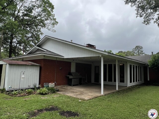 6 Arnold Dr, Texarkana, AR 71854 - rear view of house with a storage unit, a yard, an outbuilding, and a patio area
