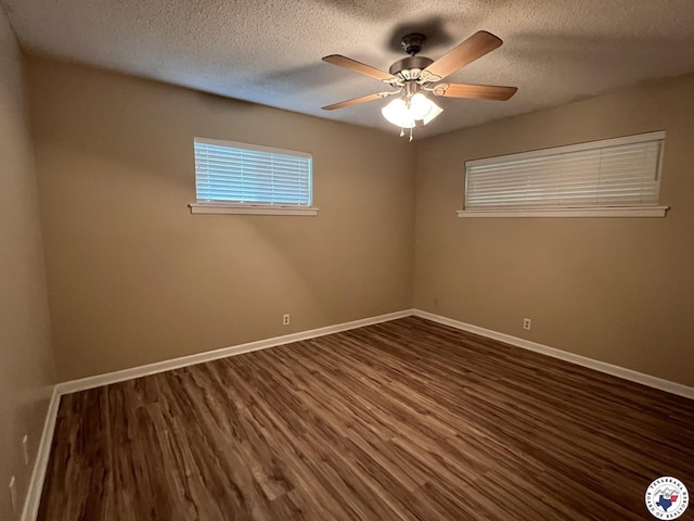 6 Arnold Dr, Texarkana, AR 71854 - empty room with wood finished floors, baseboards, a textured ceiling, and plenty of natural light