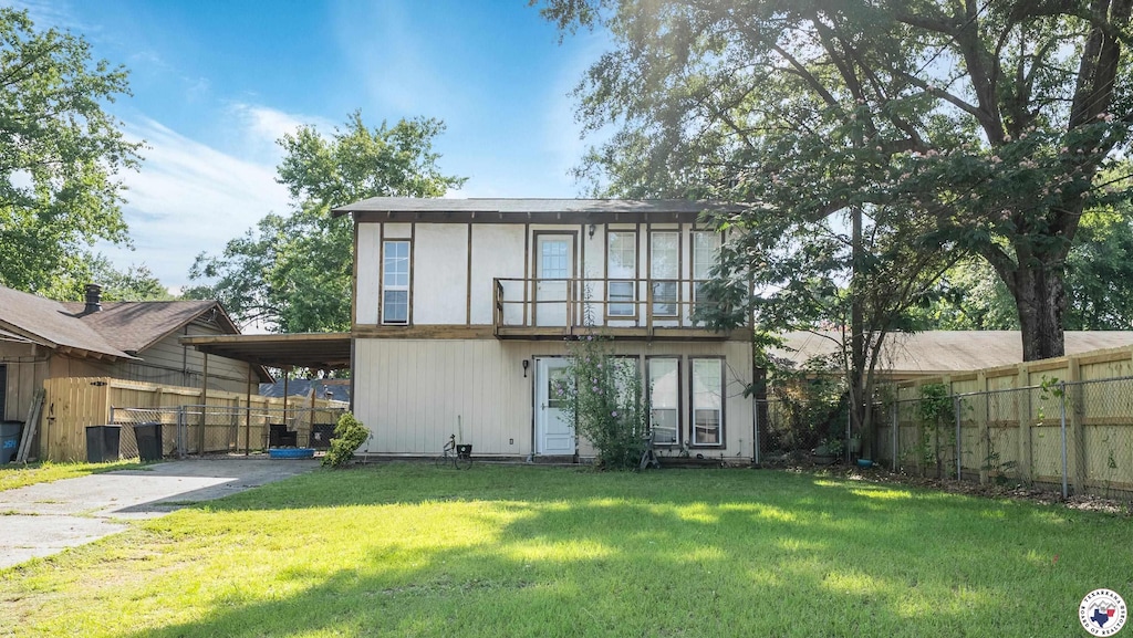 2521 Jefferson Ave, Texarkana, AR 71854 - rear view of house featuring concrete driveway and a carport