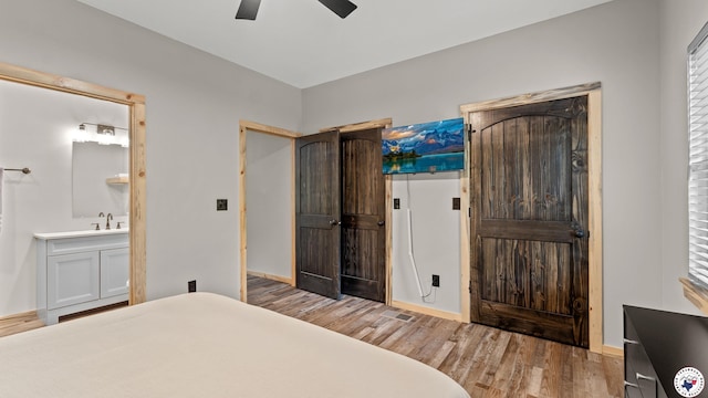 228 Old Factory Site Rd, Murfreesboro, AR 71958 - bedroom featuring wood finished floors, ceiling fan, baseboards, and connected bathroom