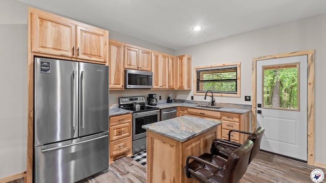 228 Old Factory Site Rd, Murfreesboro, AR 71958 - kitchen with appliances with stainless steel finishes, a sink, light brown cabinetry, light wood-style floors, and light stone counters