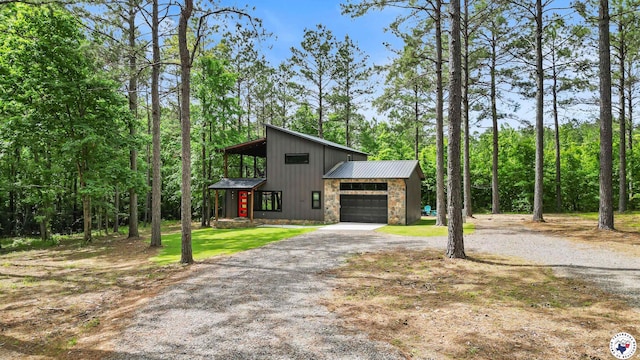228 Old Factory Site Rd, Murfreesboro, AR 71958 - view of front of property with driveway, stone siding, metal roof, a front yard, and a garage