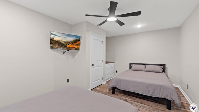 228 Old Factory Site Rd, Murfreesboro, AR 71958 - bedroom with wood finished floors, ceiling fan, and baseboards