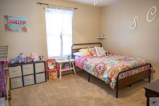 bedroom featuring light colored carpet and multiple windows