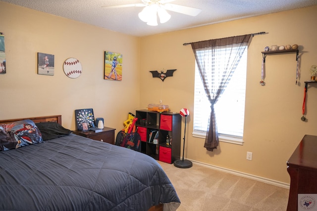 carpeted bedroom with a textured ceiling and ceiling fan