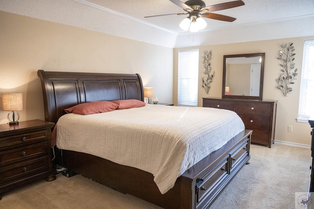 bedroom featuring light carpet, a textured ceiling, and ceiling fan