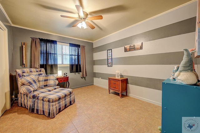 living area with tile patterned floors, ceiling fan, and ornamental molding