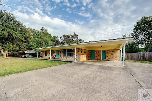 ranch-style home featuring a front yard and a carport