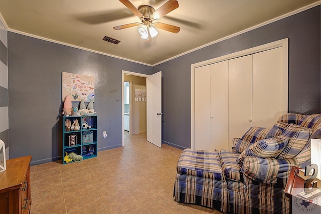 bedroom featuring ceiling fan, a closet, and crown molding