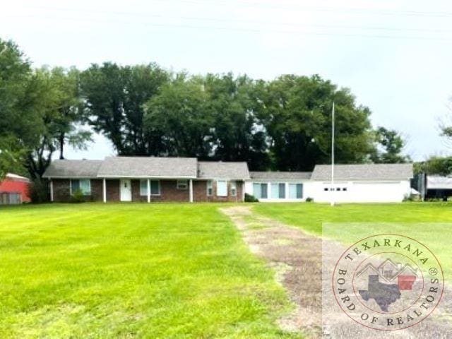 ranch-style home with a front lawn