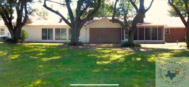 view of front of property with a front lawn and a sunroom