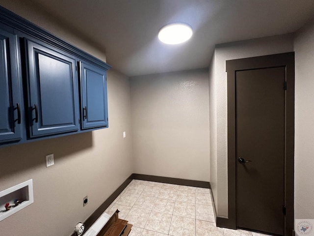 clothes washing area featuring hookup for a washing machine, hookup for an electric dryer, light tile patterned floors, and cabinets