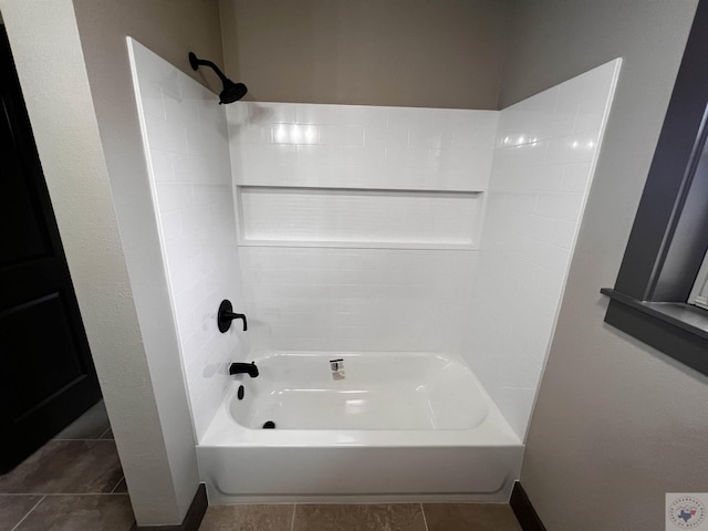 bathroom with tile patterned floors and shower / washtub combination