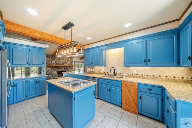 kitchen featuring blue cabinetry, a kitchen island, appliances with stainless steel finishes, and a sink