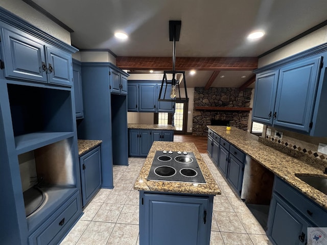 kitchen featuring beam ceiling, electric stovetop, blue cabinetry, and a kitchen island