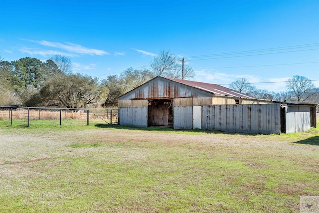 view of outbuilding with fence and an outdoor structure