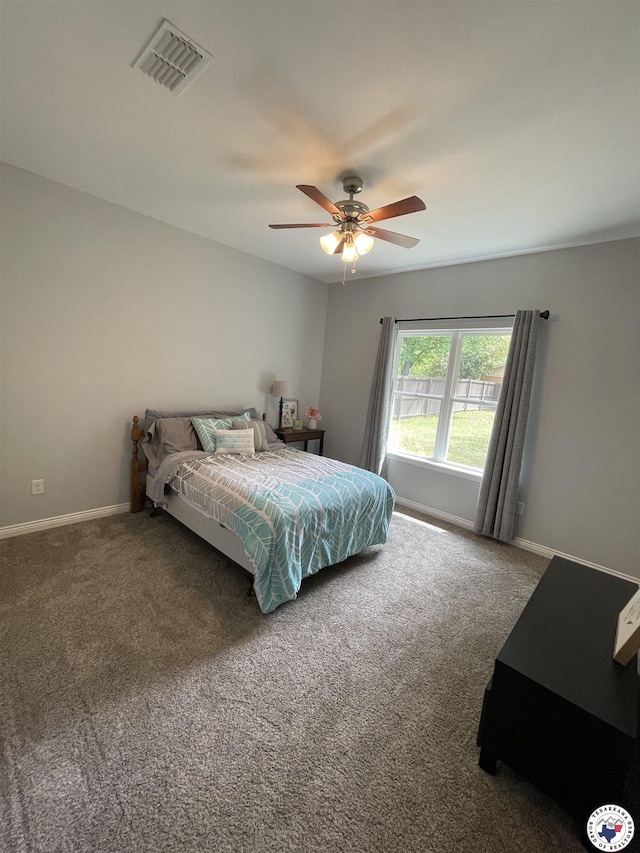 bedroom with carpet floors, visible vents, a ceiling fan, and baseboards