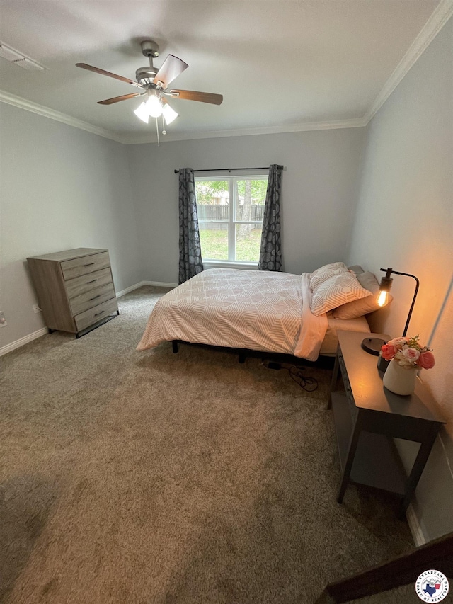 carpeted bedroom with ceiling fan, baseboards, and crown molding