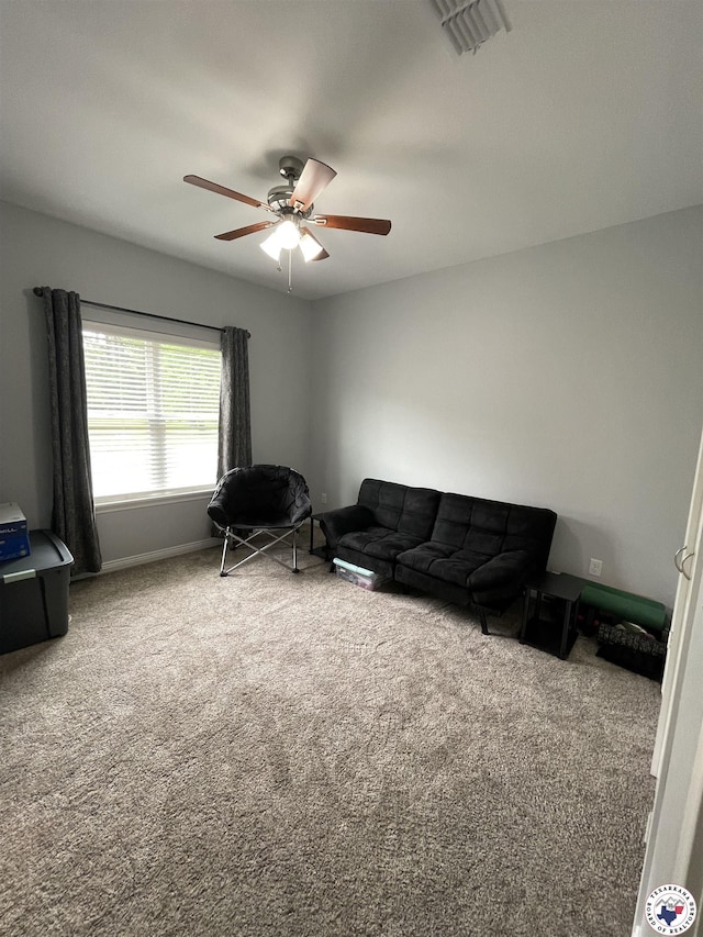 carpeted living room with ceiling fan, baseboards, and visible vents