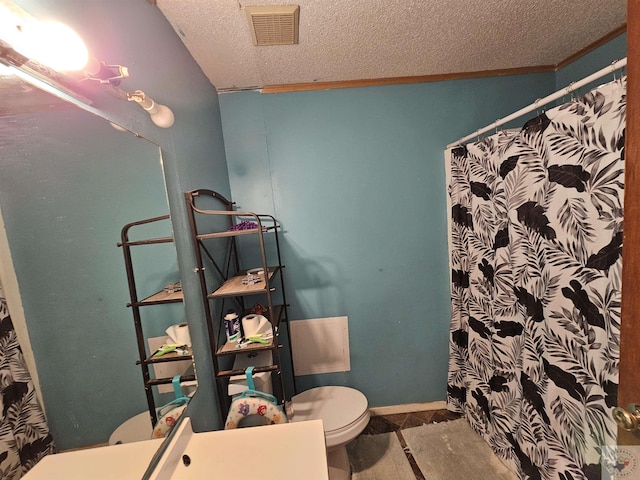 bathroom with toilet, a textured ceiling, vanity, and ornamental molding