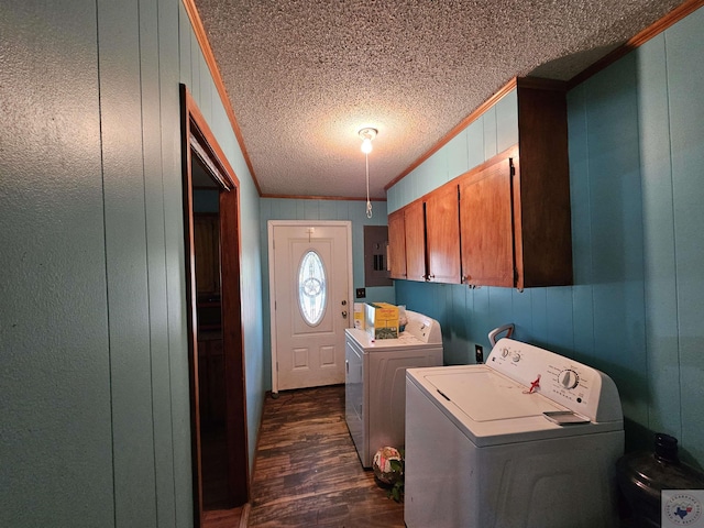 laundry room featuring crown molding, wooden walls, washer and dryer, dark hardwood / wood-style floors, and cabinets