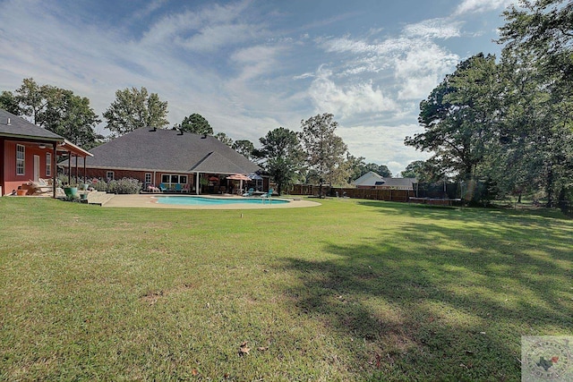 view of yard featuring a patio area, a fenced in pool, and a trampoline