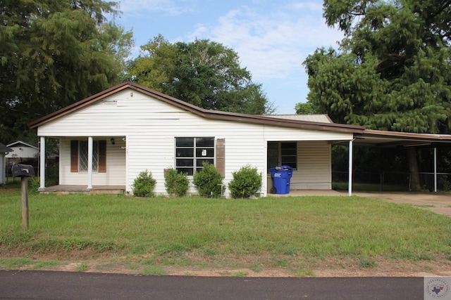 view of front facade with a carport and a front lawn