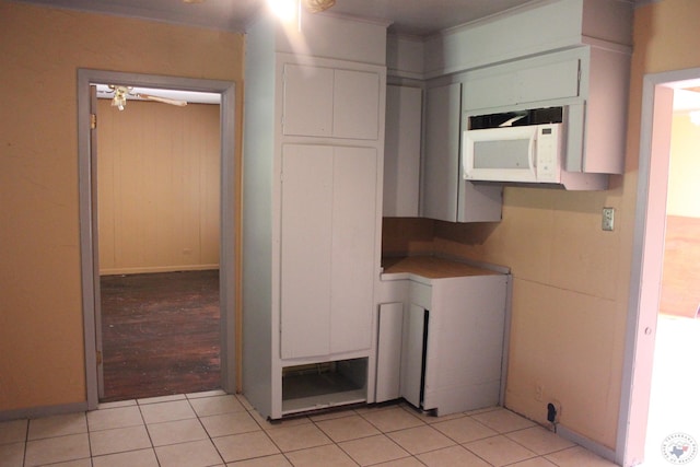 kitchen with white cabinets and light tile patterned flooring