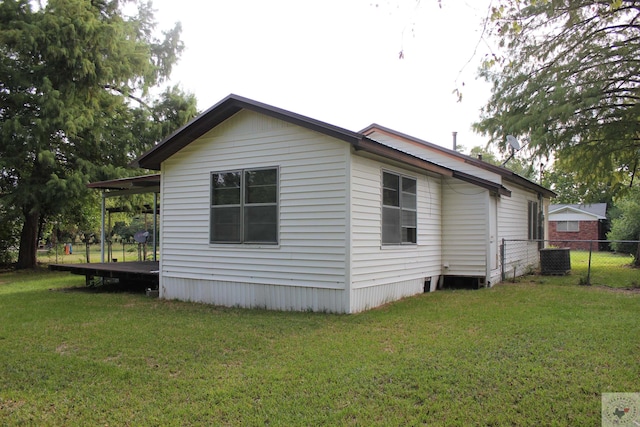 view of side of property with a lawn